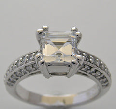 FEMININE RING SETTING FOR PRINCESS SHAPE STONE SET WITH ROUND DIAMONDS