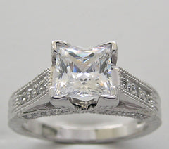 UNUSUAL RING SETTING FOR PRINCESS CUT ACCENTED WITH ROUND DIAMOND DETAILS