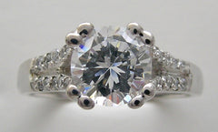 ELEGANT DIAMOND ACCENTED ENGAGEMENT RING SETTING FOR A ROUND CENTRAL STONE