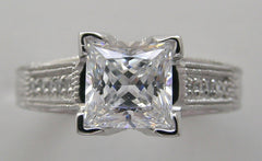 UNUSUAL RING SETTING FOR PRINCESS CUT ACCENTED WITH ROUND DIAMOND DETAILS