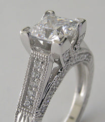 UNUSUAL RING SETTING FOR PRINCESS CUT ACCENTED WITH ROUND DIAMOND DETAILS