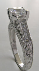 UNUSUAL RING SETTING FOR PRINCESS CUT ACCENTED WITH ROUND DIAMOND DETAILS