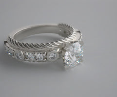 UNUSUAL ENGAGEMENT RING SETTING WITH FEMININE DIAMOND ACCENTS