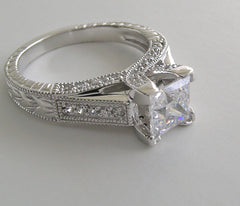 UNUSUAL RING SETTING FOR PRINCESS CUT ACCENTED WITH ROUND DIAMOND DETAILS